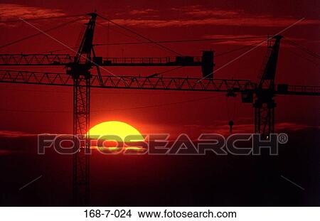 Industry, Outdoors, Sun, Sunrise, Cranes, Industrial, Construction View Large Photo Image Picture - Industry, Outdoors, Sun, Sunrise, Cranes, Industrial, Construction. Fotosearch