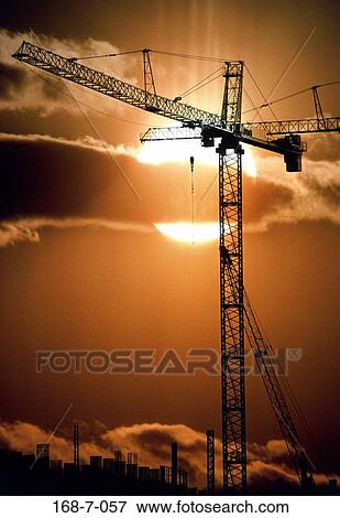 Stock Photo - Sunrise, Construction, Equipment, Building, Crane, Construction, Silhouette. Fotosearch