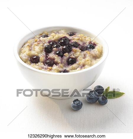Stock Photograph - A bowl of oatmeal with blueberries. Fotosearch