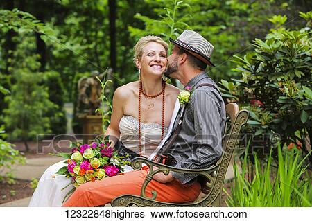 A bride and groom sit on a bench in a garden; Oregon, United States of America View Large Photo Image Stock Photograph - A bride and groom sit on a bench in a garden; Oregon, United States of America. Fotosearch