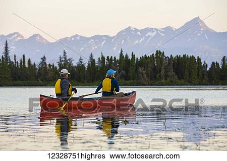 Stock Photograph - A couple canoeing on Stone Step Lake; Homer, Alaska, United States of America. Fotosearch