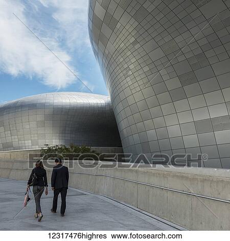 A couple walks outside Dongdaemun Design Plaza; Seoul, South Korea View Large Photo Image Stock Photograph - A couple walks outside Dongdaemun Design Plaza; Seoul, South Korea. Fotosearch