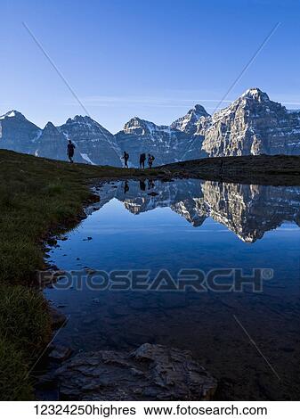 Stock Photograph - A family climbing in the Rocky Mountains; Banff, Alberta, Canada. Fotosearch
