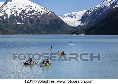Stock Photograph - A family enjoying water sports on Portage Lake in Portage Valley, Summer, Alaska, USA.. Fotosearch