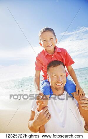 A father and son spending time on a tropical beach on vacation; Honolulu, Oahu, Hawaii, United States of America View Large Photo Image Stock Photograph - A father and son spending time on a tropical beach on vacation; Honolulu, Oahu, Hawaii, United States of America. Fotosearch