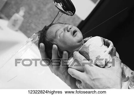 A father holds his newborn baby and holds his hair under running water while washing it; Oregon, United States of America View Large Photo Image Stock Photograph - A father holds his newborn baby and holds his hair under running water while washing it; Oregon, United States of America. Fotosearch