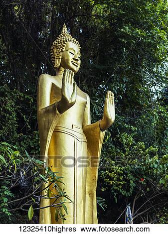 Stock Photograph - A golden buddhist statue; Luang Prabang, Luang Prabang Province, Laos. Fotosearch