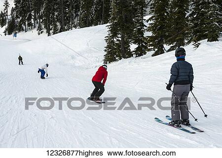 A group of skiers and snowboarders making their way down a hill; Whistler, British Columbia, Canada View Large Photo Image Stock Photograph - A group of skiers and snowboarders making their way down a hill; Whistler, British Columbia, Canada. Fotosearch