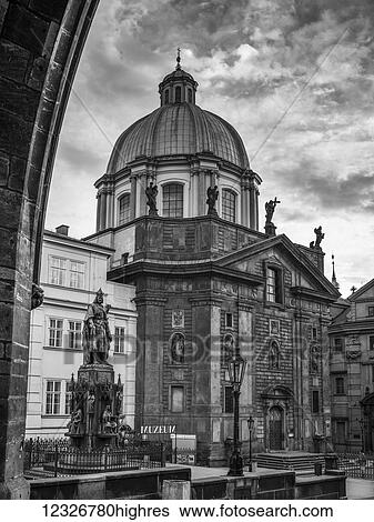 A historic church building with a dome and statues under a cloudy sky; Prague, Czech Republic View Large Photo Image Stock Photograph - A historic church building with a dome and statues under a cloudy sky; Prague, Czech Republic. Fotosearch