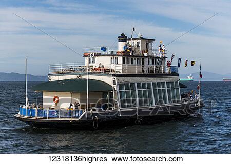 Stock Photograph - A historic ferry boat returns to Astoria; Astoria, Oregon, United States of America. Fotosearch