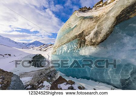 Stock Photograph - A large piece of exposed glacier ice in the moraine of Black Rapids Glacier in the winter; Alaska, United States of America. Fotosearch