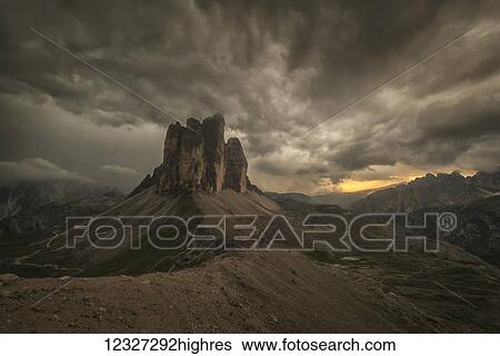 Stock Photograph - A large thunderstorm looms over Tre Cime in Natural Park Tre Cime in the Italian Dolomites; Cortina, Italy. Fotosearch
