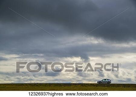 A lone car drives on the highway on the Snaefellsness Peninsula; Iceland View Large Photo Image Stock Photograph - A lone car drives on the highway on the Snaefellsness Peninsula; Iceland. Fotosearch
