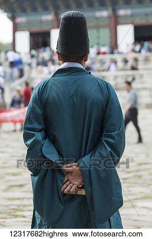 A man in a tall hat and green robe stands in front of Gyeongbokgung Palace; Seoul, South Korea View Large Photo Image Stock Photograph - A man in a tall hat and green robe stands in front of Gyeongbokgung Palace; Seoul, South Korea. Fotosearch
