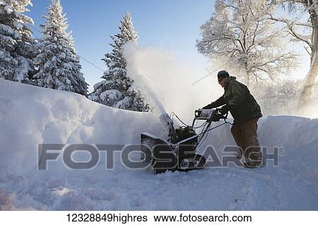 A man uses a snowblower in the deep snow; Homer, Alaska, United States of America View Large Photo Image Stock Photograph - A man uses a snowblower in the deep snow; Homer, Alaska, United States of America. Fotosearch