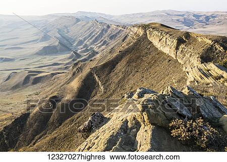 Stock Photograph - A mountain ridge at the disputable Georgia�Azerbaijan border with clearly visible remains of ancient monastery tower; Kakheti, Georgia. Fotosearch