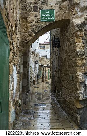 A narrow walkway lined with stone walls; Israel View Large Photo Image Stock Photograph - A narrow walkway lined with stone walls; Israel. Fotosearch