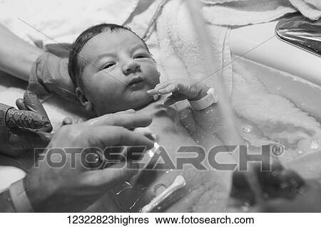 A nurse and father gives a newborn baby it's first bath; Oregon, United States of America View Large Photo Image Stock Photograph - A nurse and father gives a newborn baby it's first bath; Oregon, United States of America. Fotosearch