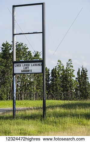 Stock Photograph - A old retail sign along the road with a message showing that they have left the premises; Alberta, Canada. Fotosearch