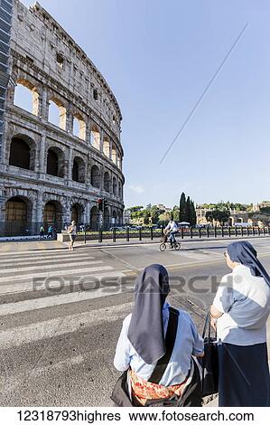 A pair of Catholic nuns outside of Vatican city wait to cross the street in front of the Colosseum; Rome, Lazio, Italy View Large Photo Image Stock Photograph - A pair of Catholic nuns outside of Vatican city wait to cross the street in front of the Colosseum; Rome, Lazio, Italy. Fotosearch