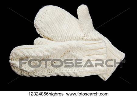 Stock Photograph - A pair of white mittens on a black background; Ontario, Canada. Fotosearch