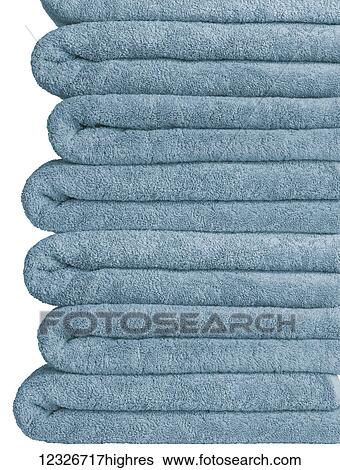 Stock Photograph - A pile of blue bath towels on a white background. Fotosearch
