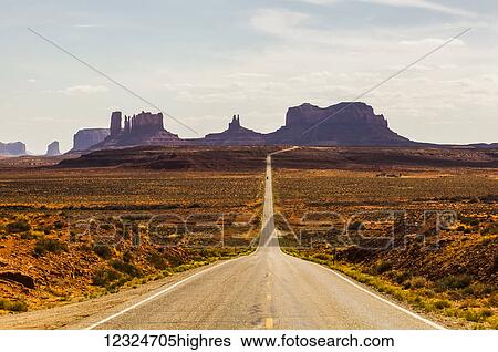 Stock Photograph - A road leading to rugged rock formations in the desert; Arizona, United States of America. Fotosearch