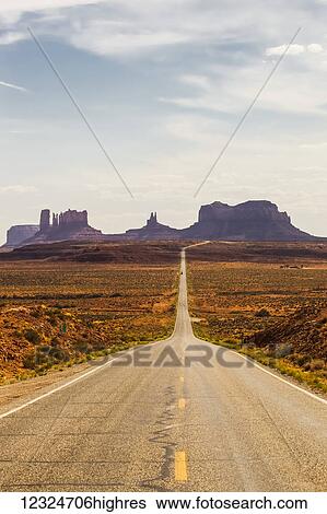 Stock Photograph - A road leading to rugged rock formations in the desert; Arizona, United States of America. Fotosearch