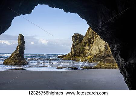 A sea cave faces Bandon Beach; Bandon, Oregon, United States of America View Large Photo Image Stock Photograph - A sea cave faces Bandon Beach; Bandon, Oregon, United States of America. Fotosearch