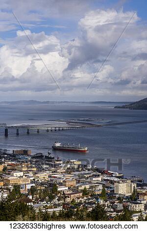 A ship passes the Astoria waterfront on a cloudy morning; Astoria, Oregon, United States of America View Large Photo Image Stock Photograph - A ship passes the Astoria waterfront on a cloudy morning; Astoria, Oregon, United States of America. Fotosearch