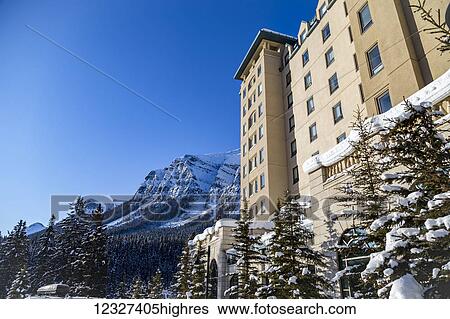 A side angle view of the winter snow covered mountains and the Fairmont Chateau Lake Louise Resort hotel in the Rocky Mountains; Lake Louise, Alberta, Canada View Large Photo Image Stock Photograph - A side angle view of the winter snow covered mountains and the Fairmont Chateau Lake Louise Resort hotel in the Rocky Mountains; Lake Louise, Alberta, Canada. Fotosearch