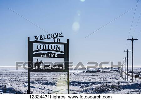 Stock Photograph - A sign saying welcome to Orion with snow covered fields in the background; Orion, Alberta, Canada. Fotosearch