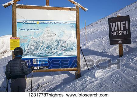 A skier stands looking at a map of the Sunshine Village ski resort with a wifi hot spot sign beside it, Banff National park; Banff, Alberta, Canada View Large Photo Image Stock Photograph - A skier stands looking at a map of the Sunshine Village ski resort with a wifi hot spot sign beside it, Banff National park; Banff, Alberta, Canada. Fotosearch