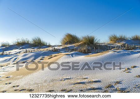 Stock Photograph - A skiff of snow on the sandy beach; South Shields, Tyne and Wear, England. Fotosearch