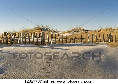 Stock Photograph - A skiff of snow on the sandy beach; South Shields, Tyne and Wear, England. Fotosearch