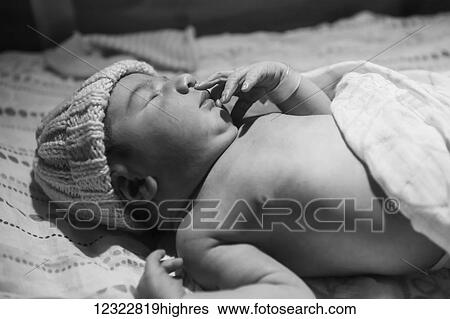 A sleeping newborn baby wearing a knit hat; Oregon, United States of America View Large Photo Image Stock Photograph - A sleeping newborn baby wearing a knit hat; Oregon, United States of America. Fotosearch