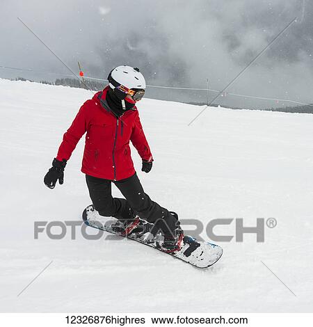 A snowboarder in a red jacket snowboarding in the Canadian Rockies; Whistler, British Columbia, Canada View Large Photo Image Stock Photograph - A snowboarder in a red jacket snowboarding in the Canadian Rockies; Whistler, British Columbia, Canada. Fotosearch