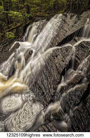 Stock Photograph - A spring waterfall in the forest; Middle Sackville, Nova Scotia, Canada. Fotosearch