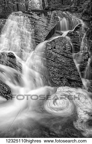 Stock Photograph - A spring waterfall in the forest; Middle Sackville, Nova Scotia, Canada. Fotosearch