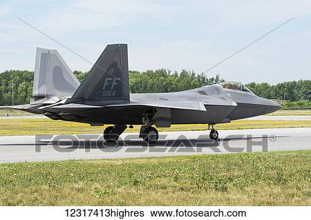 Stock Photograph - A stealth F 22 Raptor fighter jet is taxiing out for take-off; Edmonton, Alberta, Canada. Fotosearch