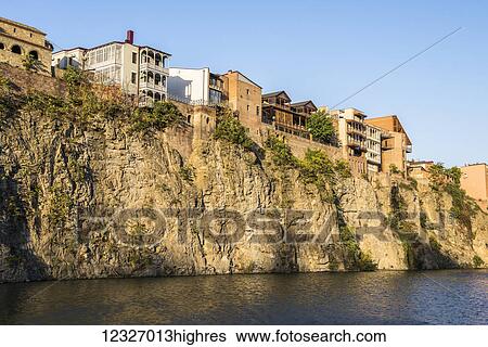 Stock Photograph - A steep bank of the Kura (Mtkvari) River in Tbilisi with compact residential planning; Tbilisi, Georgia. Fotosearch