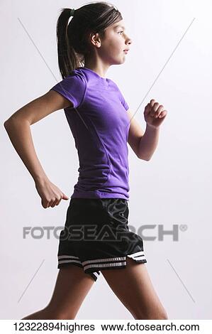 A teenage girl running against a white background; Oregon, United States of America View Large Photo Image Stock Photograph - A teenage girl running against a white background; Oregon, United States of America. Fotosearch