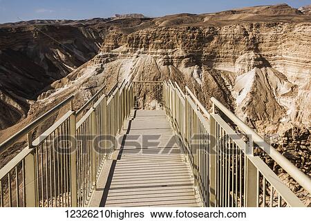Stock Photograph - A walkway with railing to an outlook over Masada and the Judaean desert; South District, Israel. Fotosearch