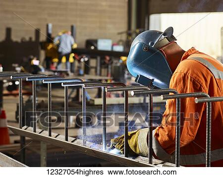 A welder wears a visor and welds in a workshop; Edmonton, Alberta, Canada View Large Photo Image Stock Photograph - A welder wears a visor and welds in a workshop; Edmonton, Alberta, Canada. Fotosearch
