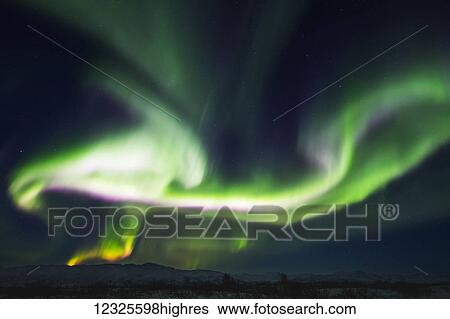 A wild aurora borealis display above the Alaska Range, south of Delta Junction; Alaska, United States of America View Large Photo Image Stock Photograph - A wild aurora borealis display above the Alaska Range, south of Delta Junction; Alaska, United States of America. Fotosearch