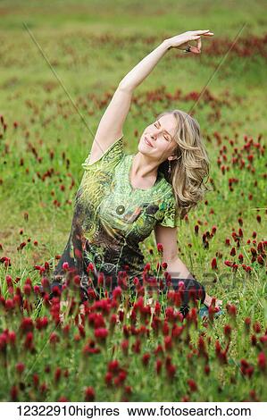 A woman does yoga in a field of wildflowers; Oregon, United States of America View Large Photo Image Stock Photograph - A woman does yoga in a field of wildflowers; Oregon, United States of America. Fotosearch