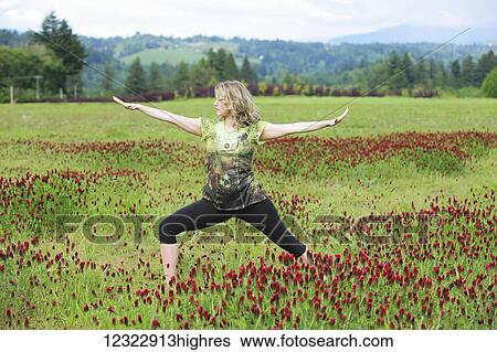 A woman does yoga in a field of wildflowers with mountains in the background; Oregon, United States of America View Large Photo Image Stock Photograph - A woman does yoga in a field of wildflowers with mountains in the background; Oregon, United States of America. Fotosearch