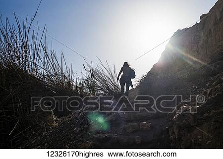 A young woman hikes up rugged, stone steps in Ein Gedi, with the sunlight illuminating the sky; South District, Israel View Large Photo Image Stock Photograph - A young woman hikes up rugged, stone steps in Ein Gedi, with the sunlight illuminating the sky; South District, Israel. Fotosearch