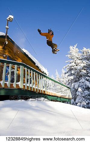A young woman jumps off the roof of her house into deep snow in the yard; Homer, Alaska, United States of America View Large Photo Image Stock Photograph - A young woman jumps off the roof of her house into deep snow in the yard; Homer, Alaska, United States of America. Fotosearch