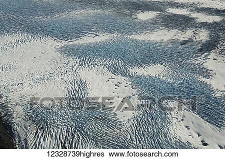 Stock Photograph - Aerial view of patterns in the snow and ice on the mountains of Fairweather Range, Glacier Bay National Park, Gulf of Alaska; Alaska, United States of America. Fotosearch